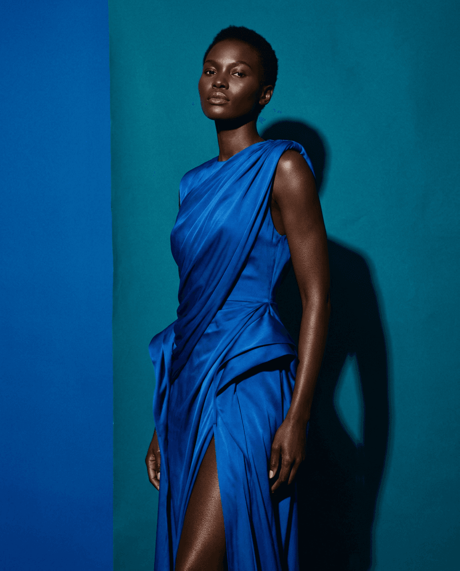 Fictional AI model — woman with a short natural crop in a cobalt silk gown